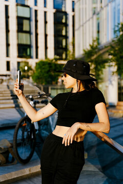 Lifestyle shot of young woman taking a picture