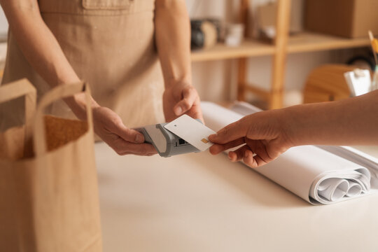 An Anonymous Customer Paying With A Credit Card 
