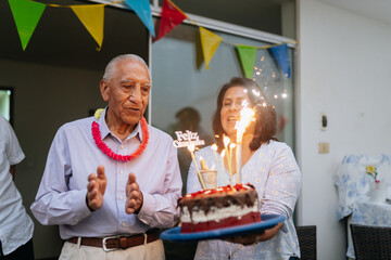 Family celebrating grandfather's birthday party