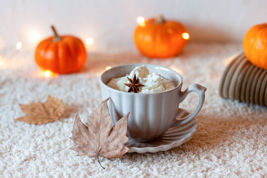 Cosy autumn composition with hot drink and mini pumpkins