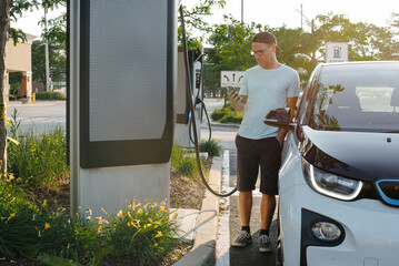Man charging his electric car