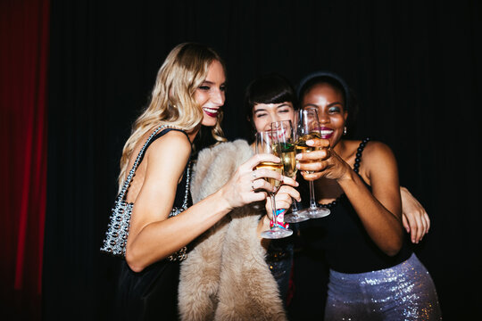 Women proposing toast during party
