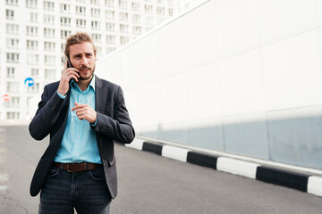 Modern man with phone in city.