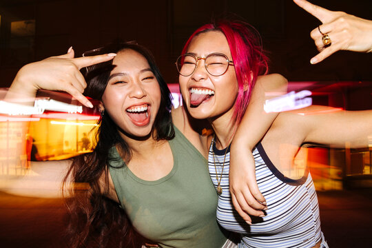 Cheerful chinese women having fun at night