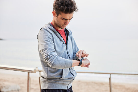Young male athlete using smart watch