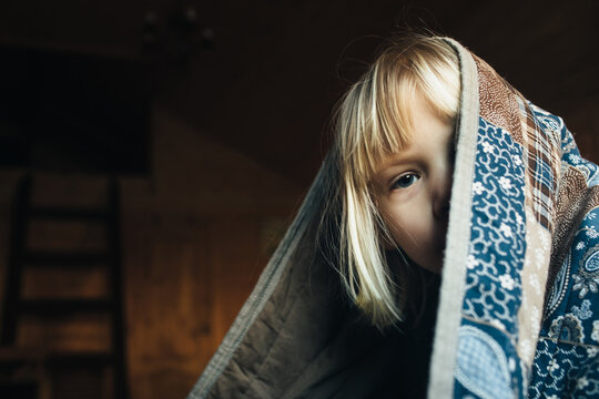 Child under the quilt
