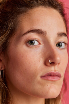 Calm freckled woman crying and looking at camera