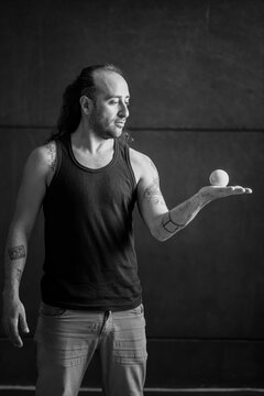 Portrait of a man looking at a ball in his hand