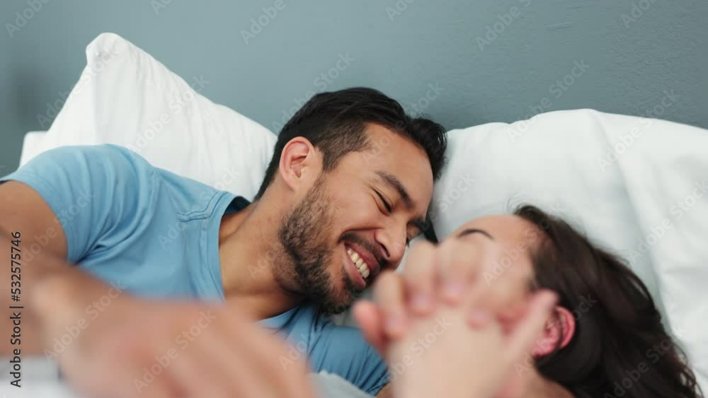 Poster Young, happy and playful couple in bed in the morning, smiling and laughing. Mixed race man and asian woman in bedroom, having fun and showing affection. Bonding, loving and quality time