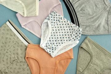 Children's underwear made of soft jersey. Panties and T-shirts for boys and girls are laid out as a background. Children's clothing. Underwear for a child.
