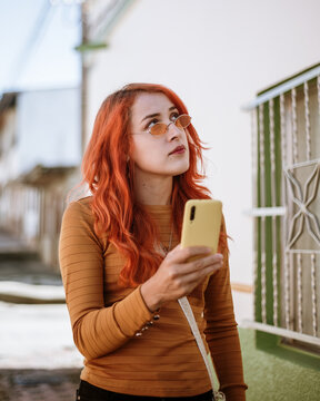 Latina woman looking for the address of a house