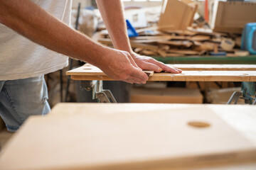 Carpenter working on wood craft at workshop. Professional tools for crafting. DIY maker and carpentry work concept. Copy space for text.