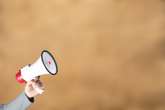 Hand Holding A Loudspeaker