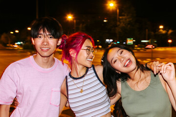 Cheerful friends having fun together at night