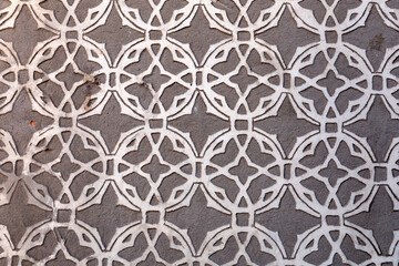 Texture background from a stucco wall covered with traditional patterns in Segovia, Spain