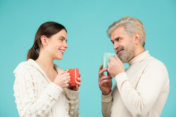Friends hold cup, coffee mug. People on isolated background with copy space. Friendly team, a coffee break, meeting friends, morning in the team.