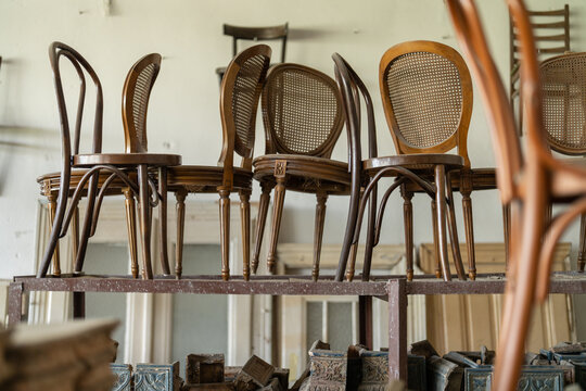Vintage old chairs standing before the renovation at the repair place