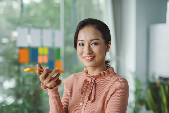 Young businesswoman work stand at a office desk talking speaking - Powered by Adobe