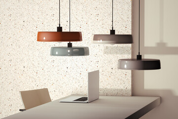 Ceiling lamps above a laptop on the table