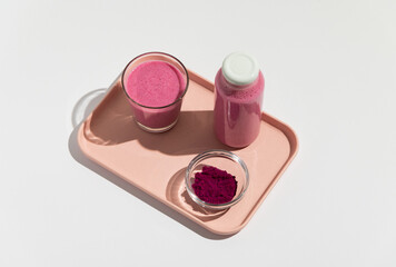 Pitaya dragon fruit healthy superfood drink with glass, bottle powder