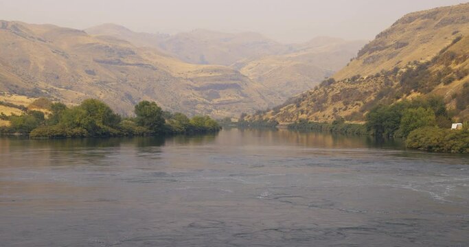 Downstream on the Snake River into Hells Canyon, the deepest river gorge in North America. Appropriately Canyon view is hazy with smoke from Oregon-California wildfires.