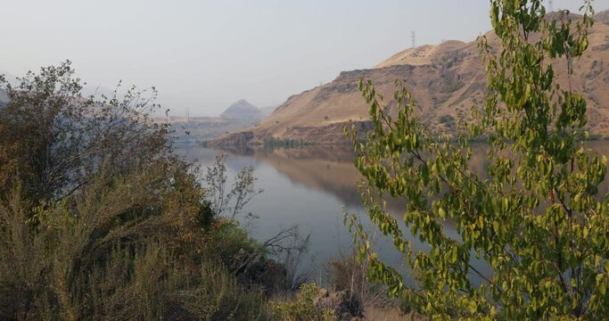 Shoreline reflects in still waters of the Snake River in Hells Canyon on the Idaho-Oregon border. Hells Canyon is a ten-mile-wide canyon and is the deepest river gorge in North America.