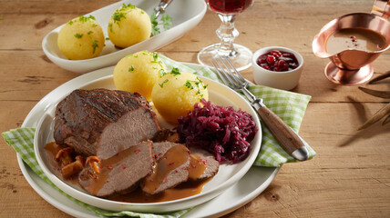 Meat dish near sauces and wine