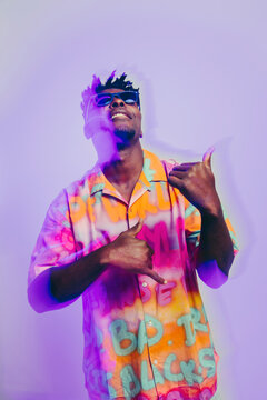 Stylish happy man dancing in studio