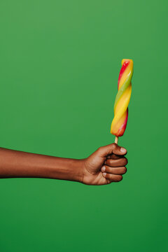 Crop Person With Ice Cream On Green Background