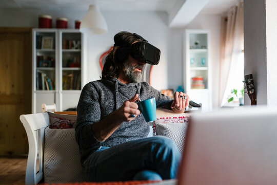 Man exploring cyberspace near laptop