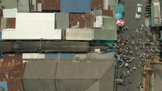 Time Lapse Maeklong Railway Market. Train pulling out of station Aerial 4k