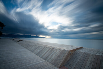 Long exposure shot of wodden sunset watching terrace, blue colored clouds moving fast and blurry movement effect