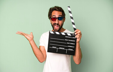 young crazy bearded and expressive man with a clapper. cinema film or movie concept