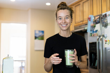 Young woman makes matcha at home