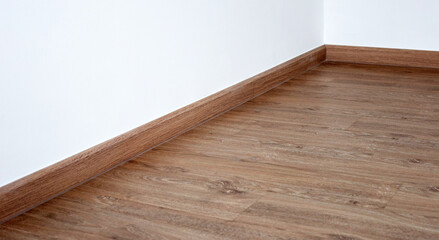 Laminate wood floor with blank white wall