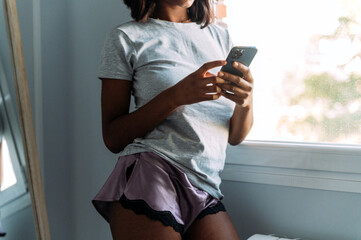 anonymous black woman using smartphone