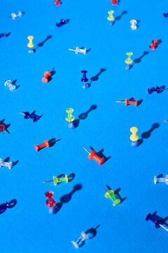 Several pins stand on a blue background