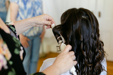 Bride Getting Hair Curled before Wedding