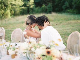 bride and groom sitting by a decorated table on their wedding day