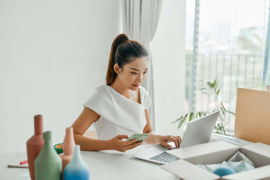 Women business owner is getting and writing the orders