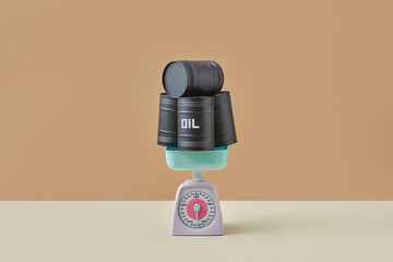 Black oil barrels on vintage scales.