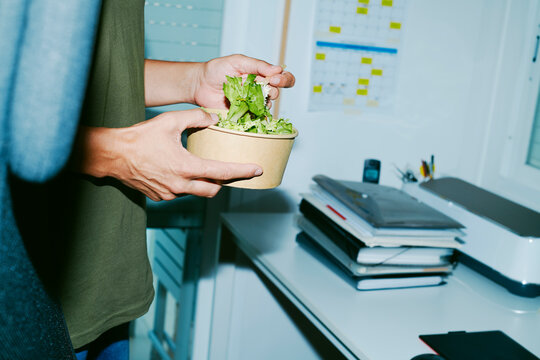 eats a salad in the office