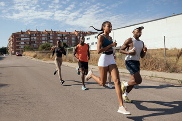 Friends jogging together in town