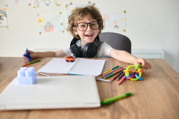 little boy painting and playing in a table