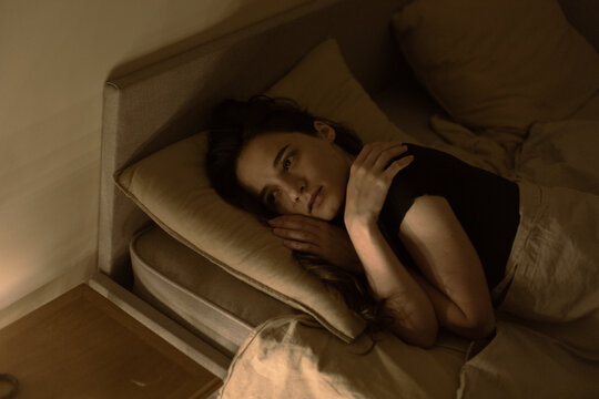girl in the dark on the bed
