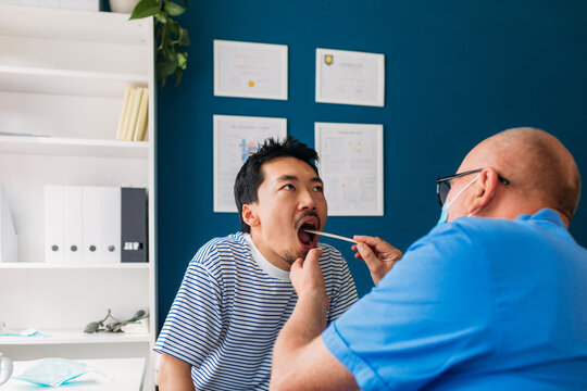 Doctor Examining Young Man 
