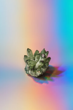 Natural healing mineral on shiny holographic background