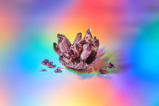 Amethyst crystal on colorful holographic background