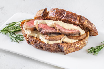 Sandwich with beef steak and mushrooms