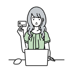 デスクで座ってPCを使いながらクレジットカードを手に持っているオフィスカジュアルの女性